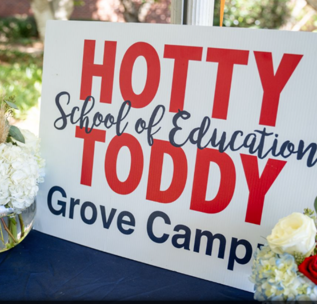 large tailgate tent with sign that reads Welcome School of Education Alumni and Friends